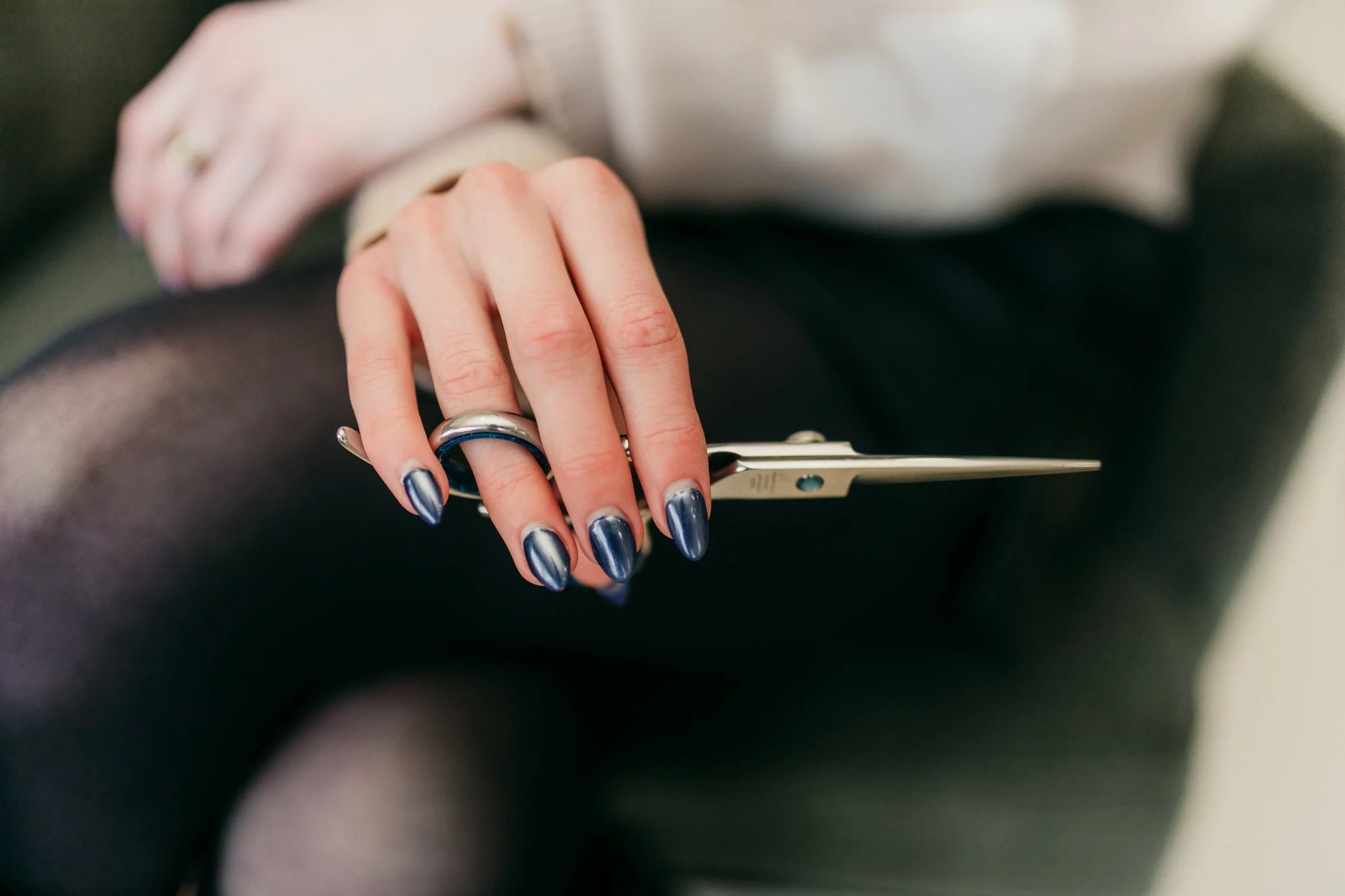 Stylist holding shears at Eve Salon, Saint Louis MO